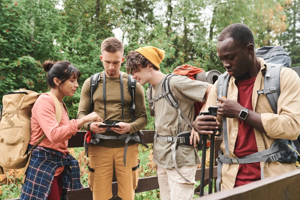 Adventure group checking maps and safety gear before a hike