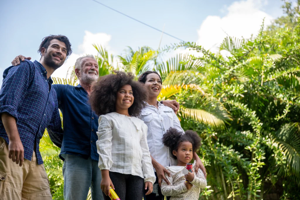 Multi-generational family group smiling together on a scenic overlook