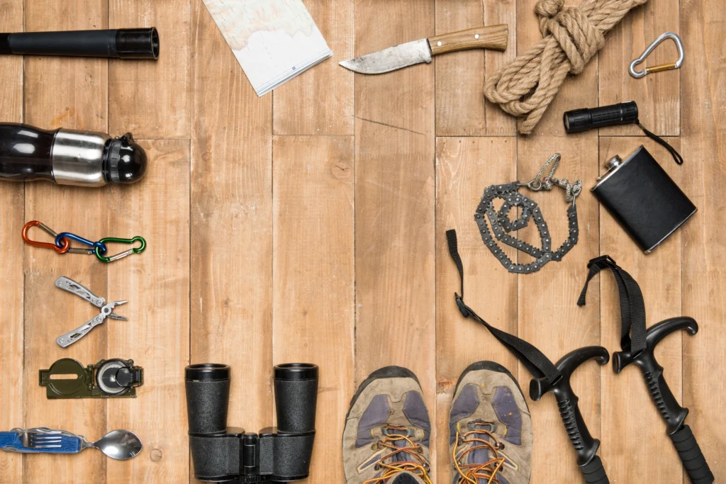 Neatly organized adventure gear laid out on a wooden surface